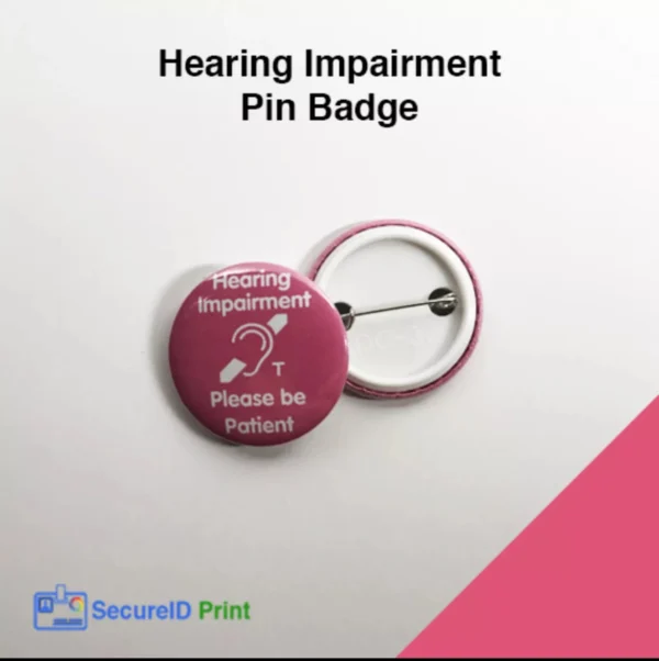 Pink hearing impairment awareness pin badge with hearing loop symbol and Please Be Patient message.